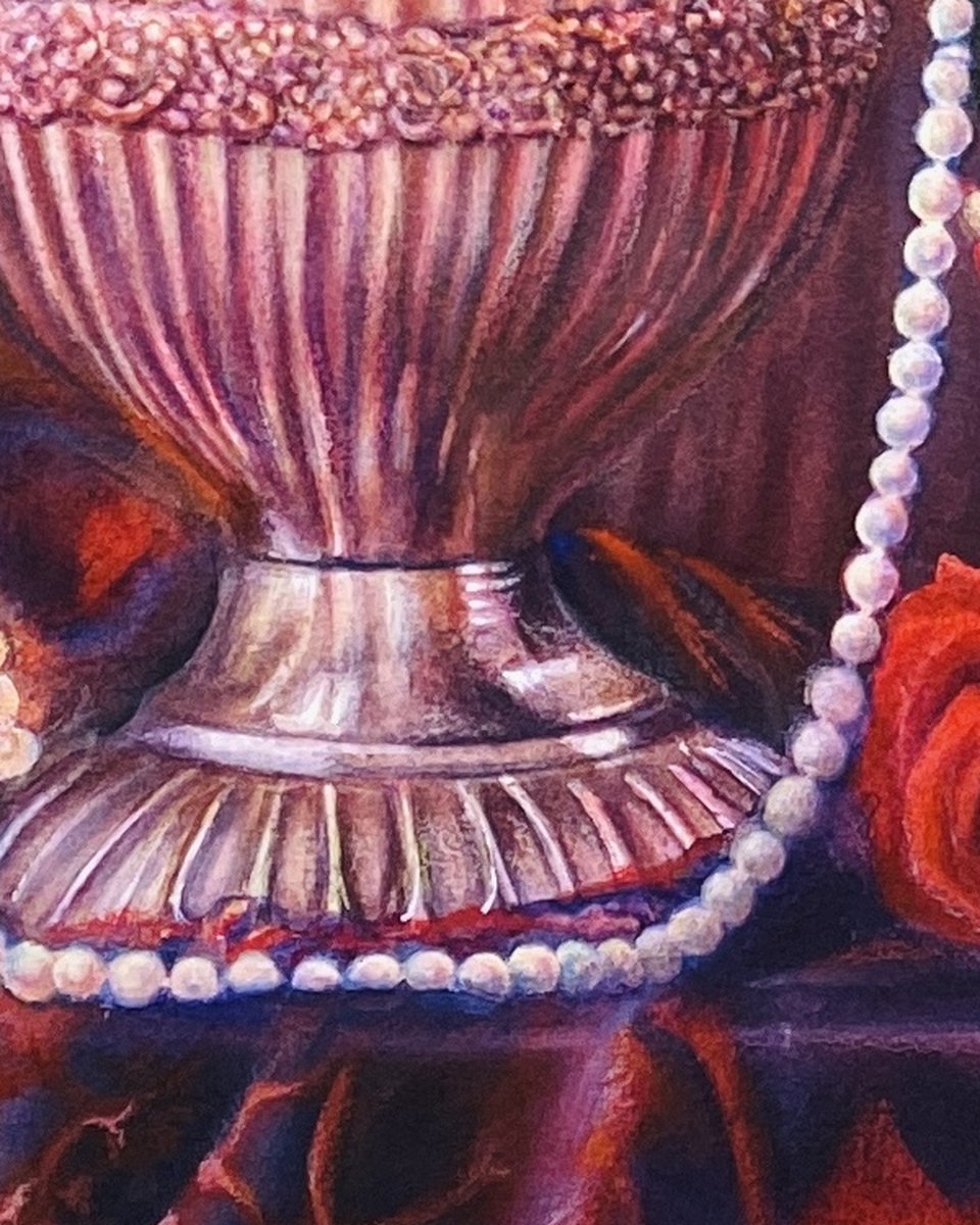 Detail of a watercolour still life: the ribbed silver foot of a chalice with strings of pearls pooled around its base on a dark red and violet patterned cloth; the brightest points on the pearls and the metal are untouched white paper.
